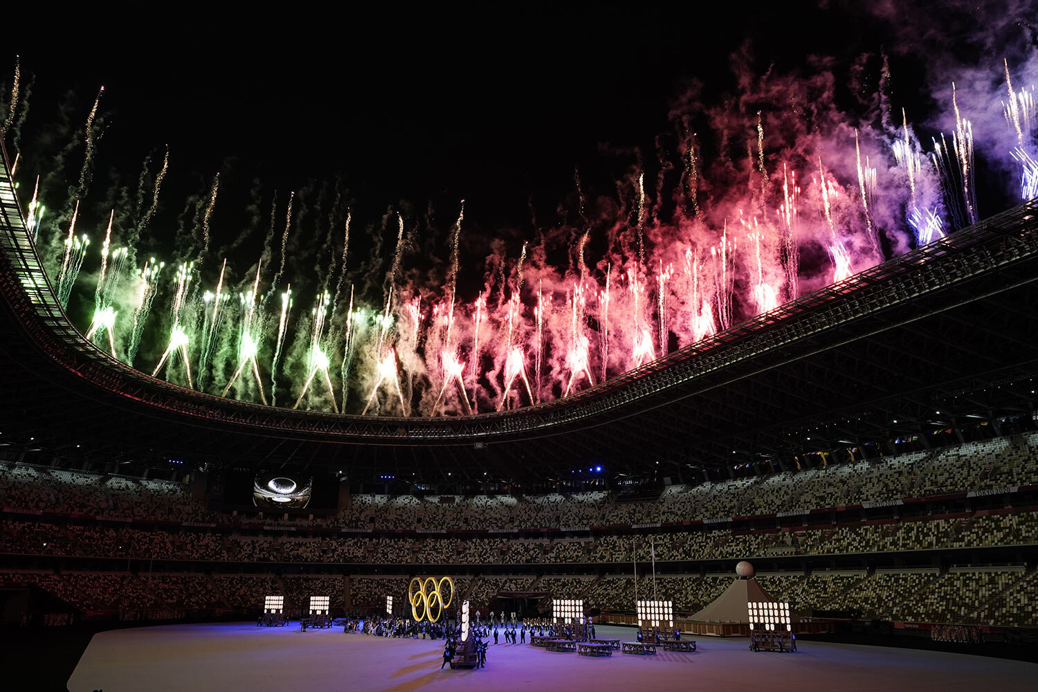  Fireworks explode from the roof of the stadium as the Olympic rings are assembled during the opening ceremony in the Olympic Stadium at the 2020 Summer Olympics, Friday, July 23, 2021, in Tokyo, Japan. (AP Photo/Ashley Landis) 