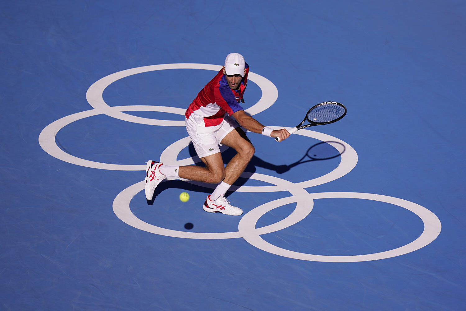  Novak Djokovic, of Serbia, returns a shot to Pablo Carreno Busta, of Spain, during the bronze medal match of the tennis competition at the 2020 Summer Olympics, Saturday, July 31, 2021, in Tokyo, Japan. (AP Photo/Seth Wenig) 