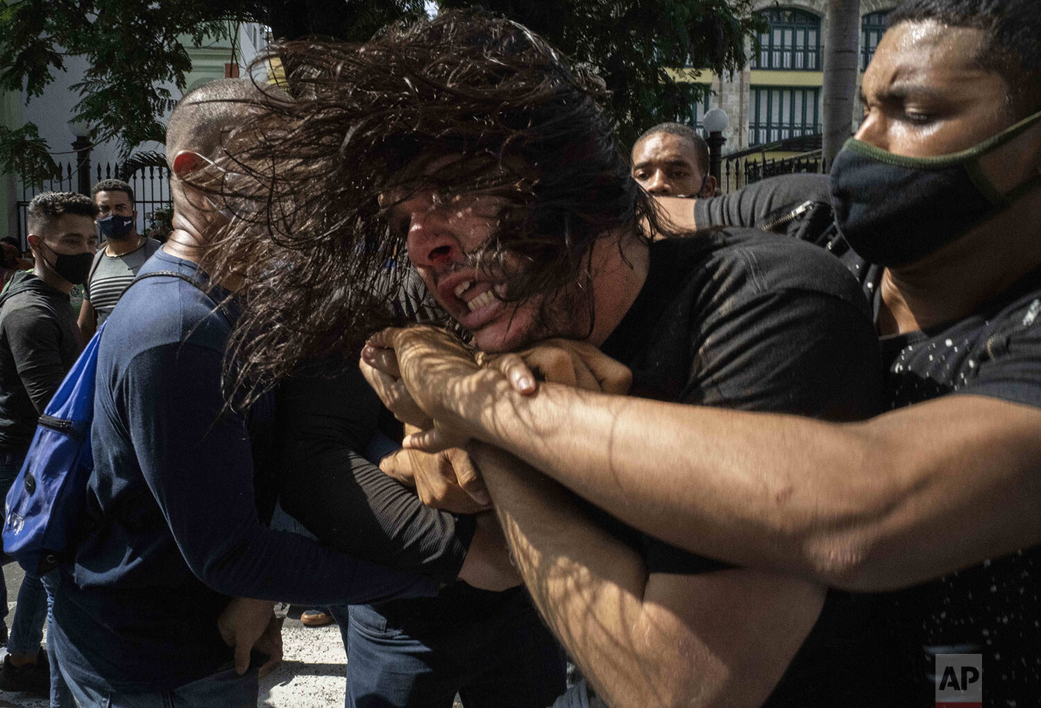  Plainclothes police detain an anti-government protester during a demonstration over high prices, food shortages and power outages, while some people also called for a change in the government, in Havana, Cuba, Sunday, July 11, 2021. Cuban President 