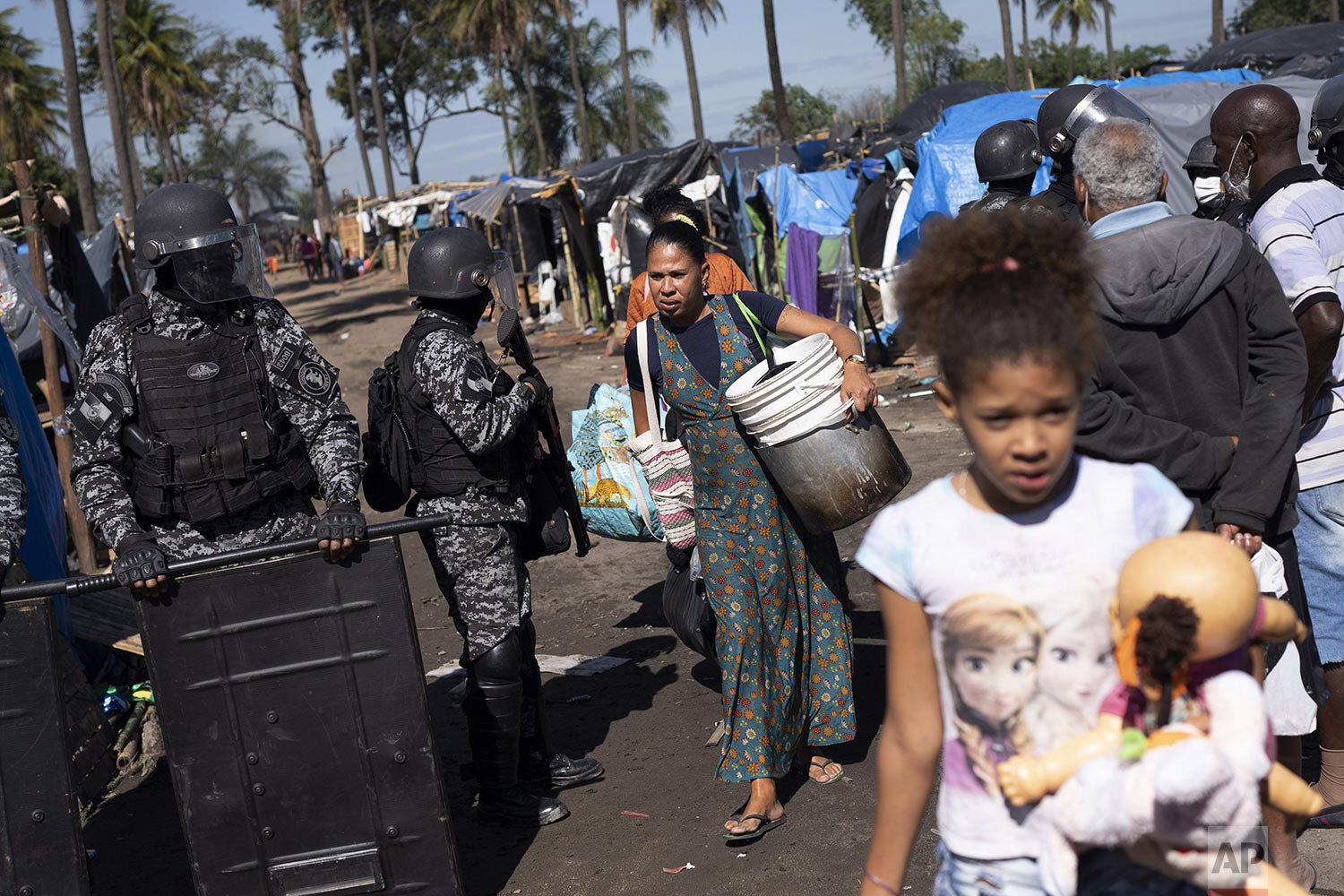  People are evicted from land designated for a Petrobras refinery, at a settlement coined the "First of May Refugee Camp," referring to the date people moved here and set up tents and shacks to live in during the new coronavirus pandemic in Itaguai, 