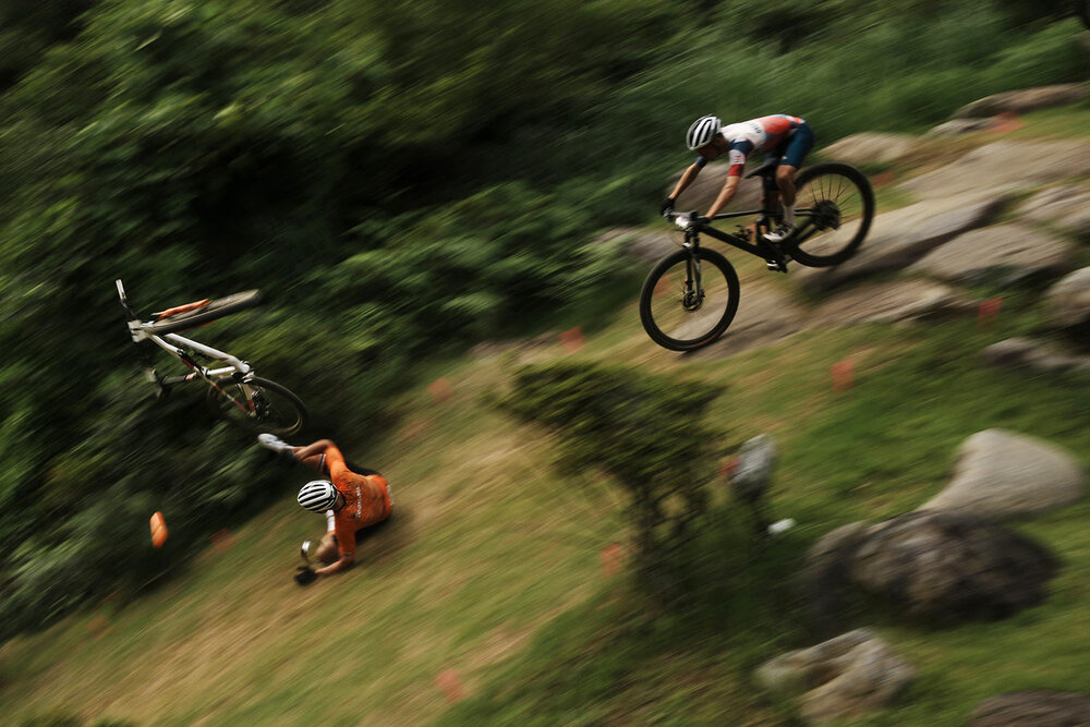  Mathieu van der Poel of the Netherlands tumbles on a downhill during the men's cross country mountain bike competition at the 2020 Summer Olympics, Monday, July 26, 2021, in Izu, Japan. (AP Photo/Thibault Camus) 