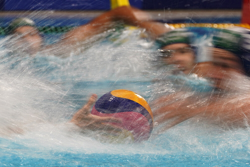  Players race for the ball at the start of a preliminary round men's water polo match between Hungary and Japan at the 2020 Summer Olympics, Tuesday, July 27, 2021, in Tokyo, Japan. (AP Photo/Mark Humphrey) 