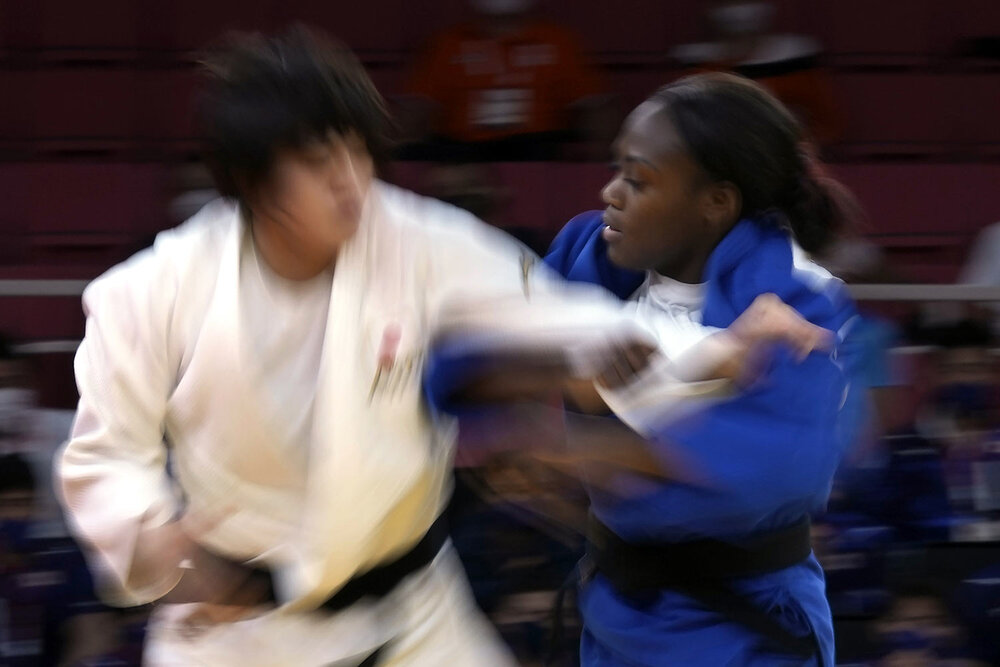  Chizuru Arai of Japan, left, and Clarisse Agbegnenou of France compete during their gold medal match in team judo competition at the 2020 Summer Olympics, Saturday, July 31, 2021, in Tokyo, Japan. (AP Photo/Vincent Thian) 