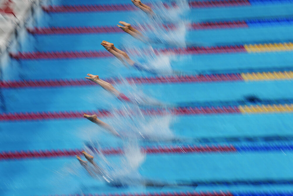  Swimmers dive in for the final of the men's 400-meter freestyle at the 2020 Summer Olympics, Sunday, July 25, 2021, in Tokyo, Japan. (AP Photo/Petr David Josek) 