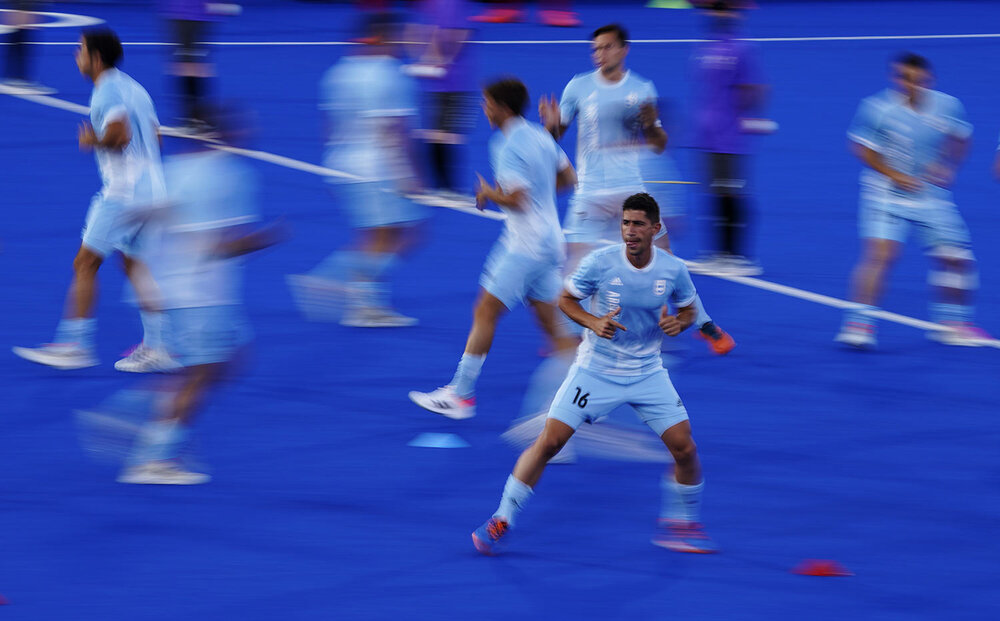  Argentina players warm up before a men's field hockey match against Japan at the 2020 Summer Olympics, Sunday, July 25, 2021, in Tokyo, Japan. (AP Photo/John Locher) 