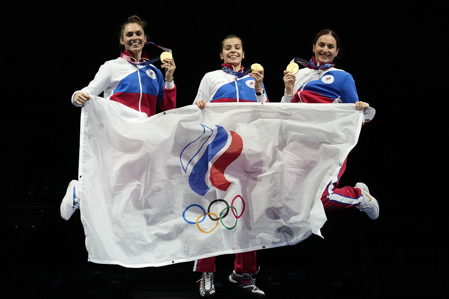  Gold medalists Russian Olympic committee Sabre team celebrate on the podium during the medal ceremony for the women's Sabre team final medal competition at the 2020 Summer Olympics, Saturday, July 31, 2021, in Chiba, Japan. (AP Photo/Hassan Ammar) 