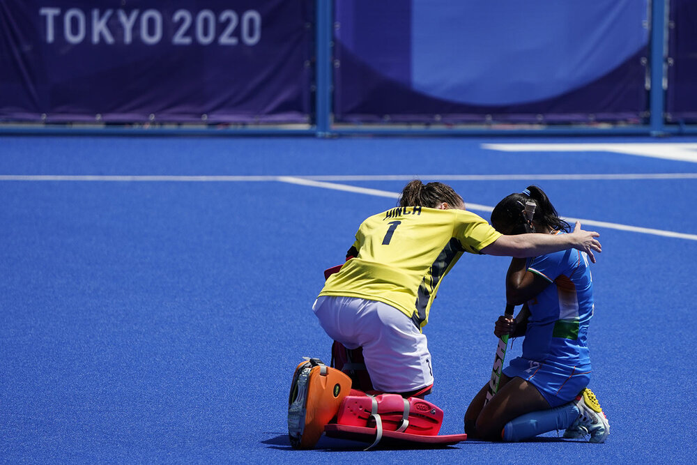  Britain's goalkeeper Claire Hinch (1) comforts India's Neha Neha, right, after winning their women's field hockey bronze medal match at the 2020 Summer Olympics, Friday, Aug. 6, 2021, in Tokyo, Japan. Britain won 4-3. (AP Photo/John Minchillo) 