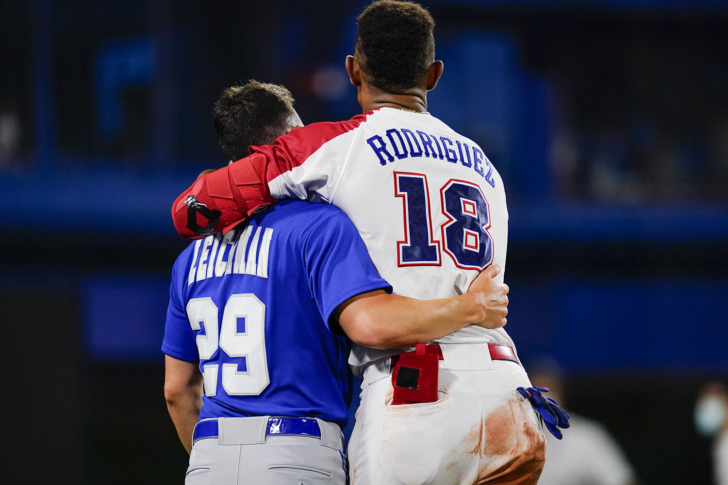  Israel's Alon Leichman, left, and the Dominican Republic's Julio Rodriguez embrace after a baseball game at the 2020 Summer Olympics, Tuesday, Aug. 3, 2021, in Yokohama, Japan. The Dominican Republic won 7-6. (AP Photo/Matt Slocum) 