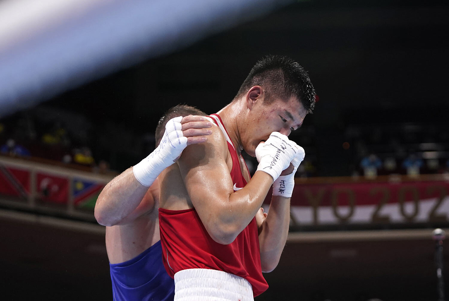  Russian Olympic Committee's Imam Khataev comforts Kazakhstan's Bekzad Nurdauletov after the former won the men's light heavyweight 81-kg preliminaries boxing match at the 2020 Summer Olympics, Wednesday, July 28, 2021, in Tokyo, Japan. (AP Photo/Fra