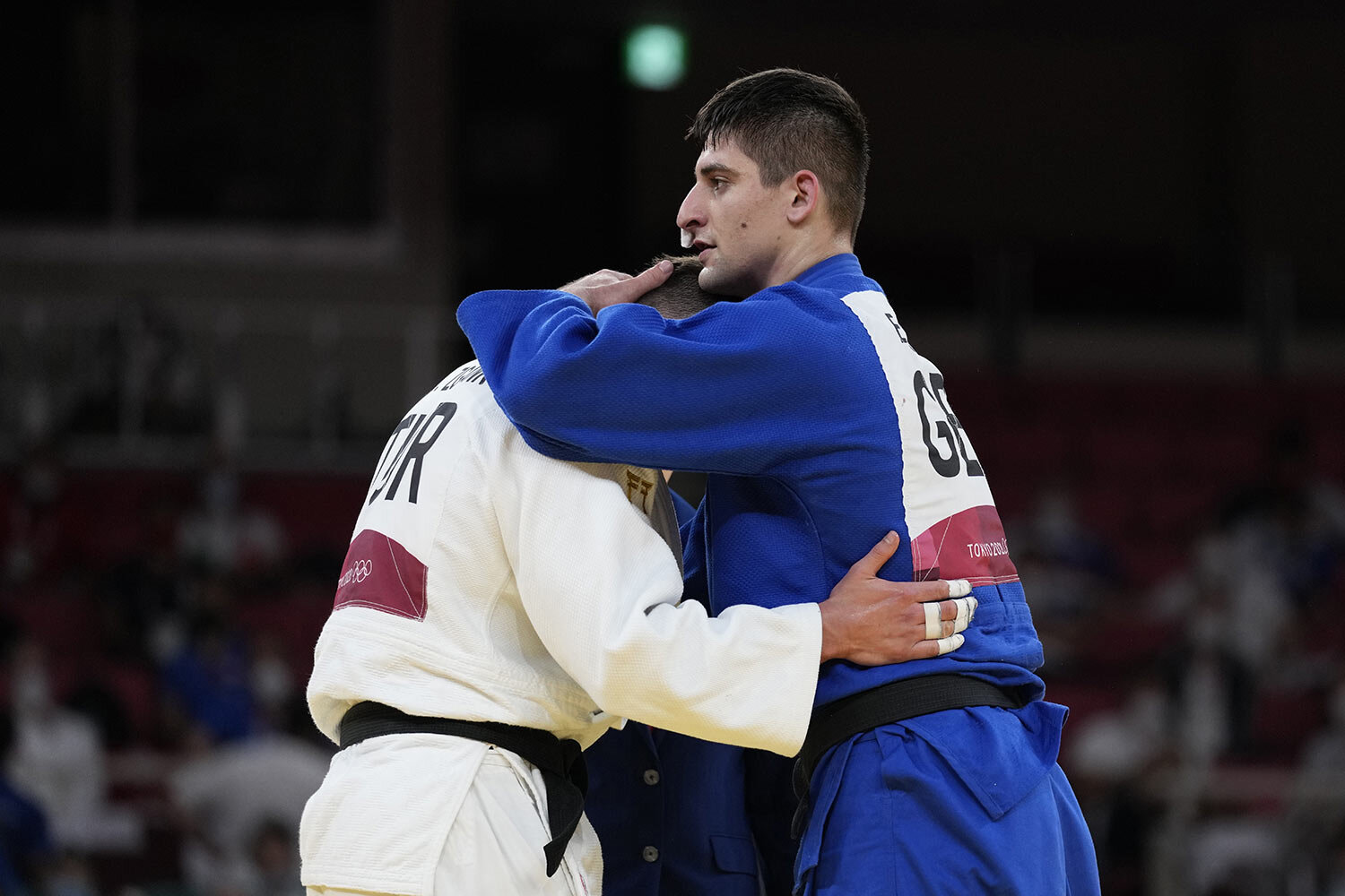  Eduard Trippel of Germany, right comforts Michael Zgank of Turkey after winning their men -90kg semifinal round against unseen, in the judo match at the 2020 Summer Olympics in Tokyo, Japan, Wednesday, July 28, 2021. (AP Photo/Vincent Thian) 
