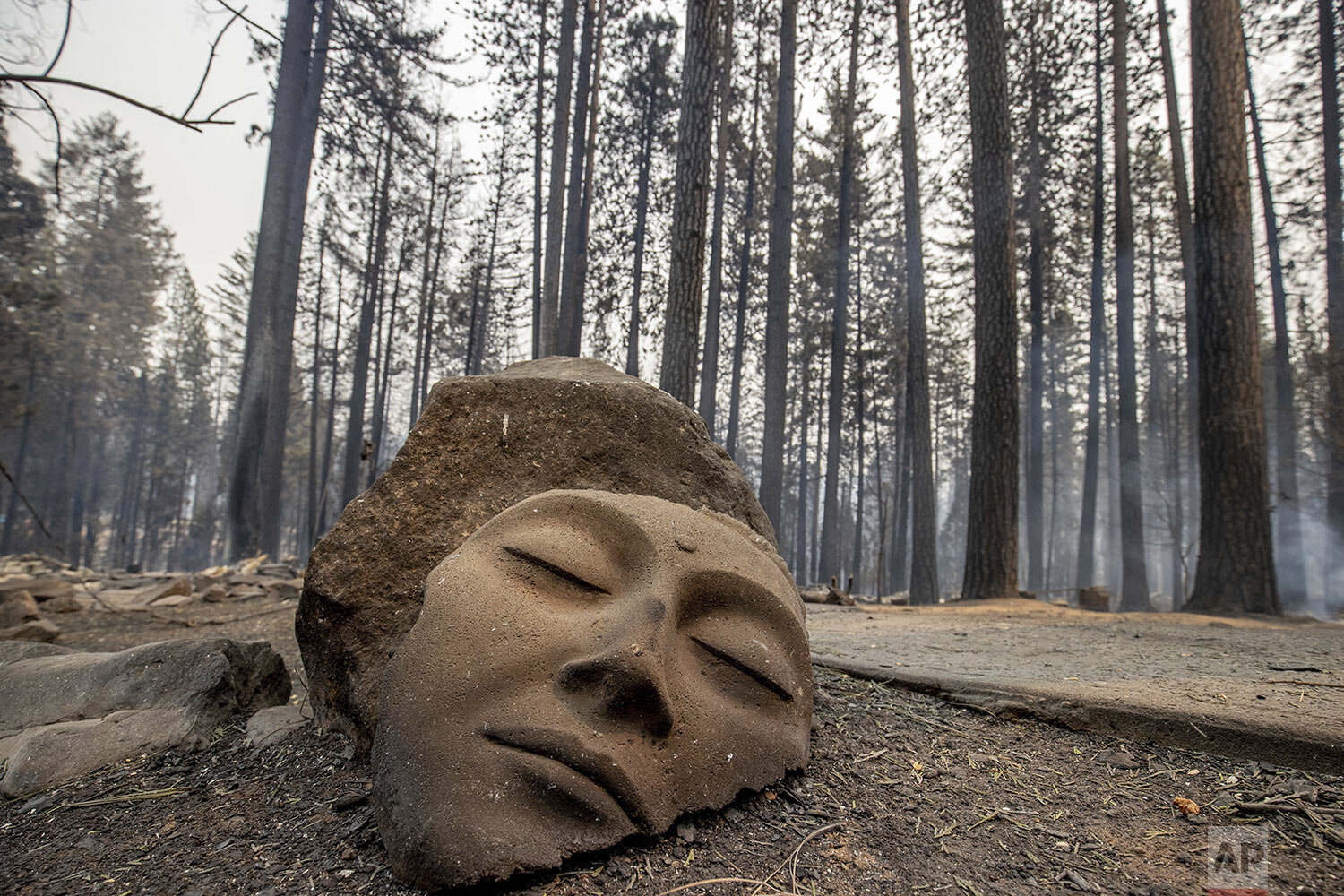  A sculpture rests in front of a Grizzly Flats home destroyed by the Caldor Fire in El Dorado County, Calif., on Tuesday, Aug. 17, 2021. (AP Photo/Ethan Swope) 