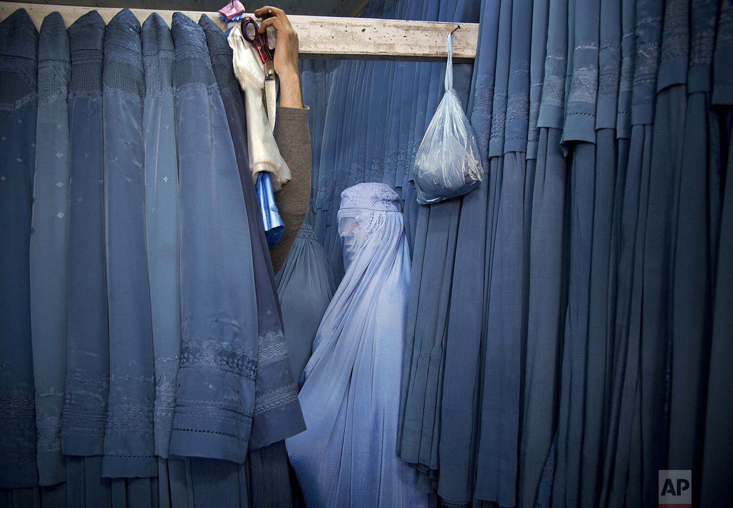  An Afghan woman waits in a changing room to try out a new Burqa, in a shop in the old city of Kabul, Afghanistan, Thursday, April 11, 2013. Before the Taliban took power in Afghanistan, the Burqa was infrequently worn in cities. While they were in p