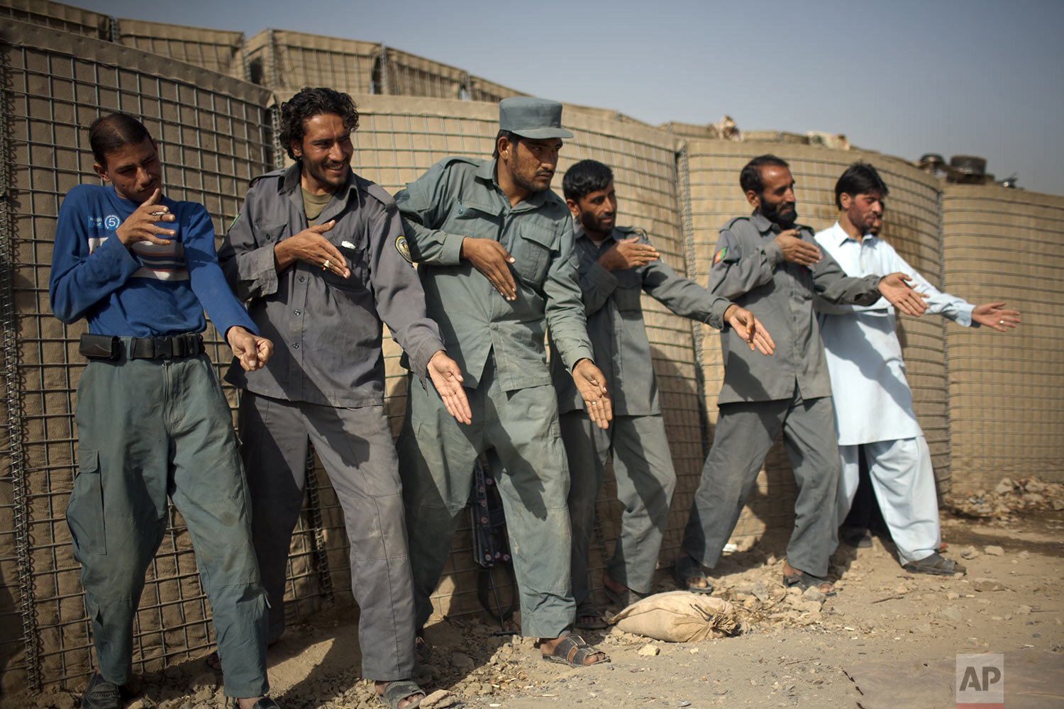  Afghan policemen simulate weapons orientation during a training session with U.S. soldiers from 2nd PLT Diablos 552nd Military Police Company, on the outskirts of Kandahar City, Afghanistan, Tuesday, Oct. 26, 2010. (AP Photo/Rodrigo Abd) 