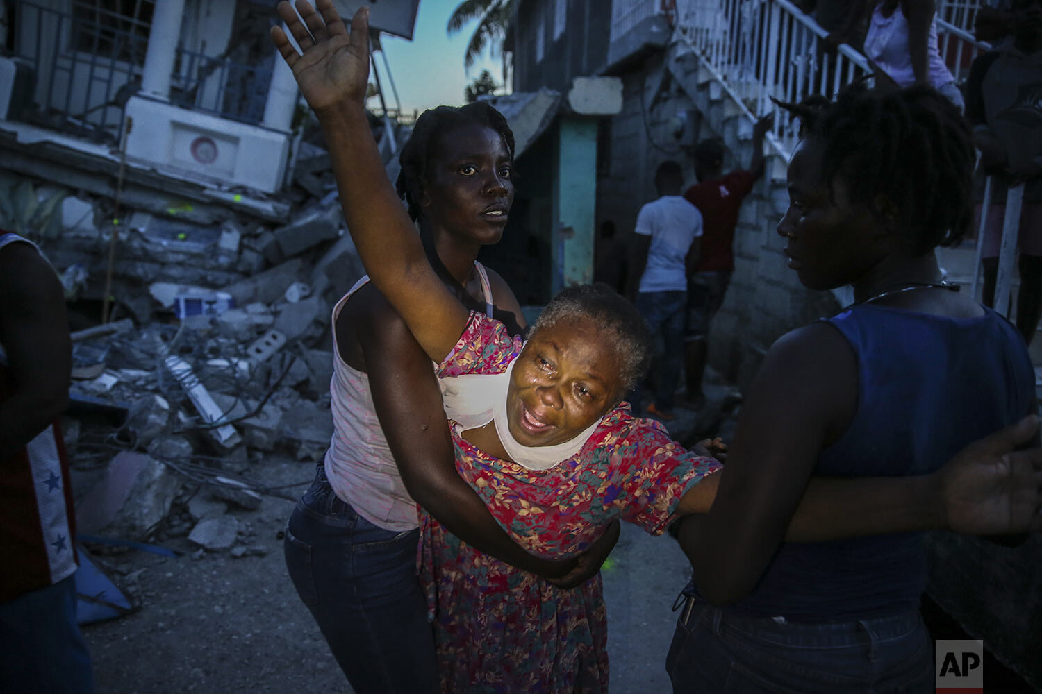  Oxiliene Morency cries out after the body of her 7-year-old-daughter Esther Daniel was recovered from the rubble of their home destroyed by the 7.2 magnitude earthquake in Les Cayes, Haiti, Aug. 14, 2021. (AP Photo /Joseph Odelyn) 
