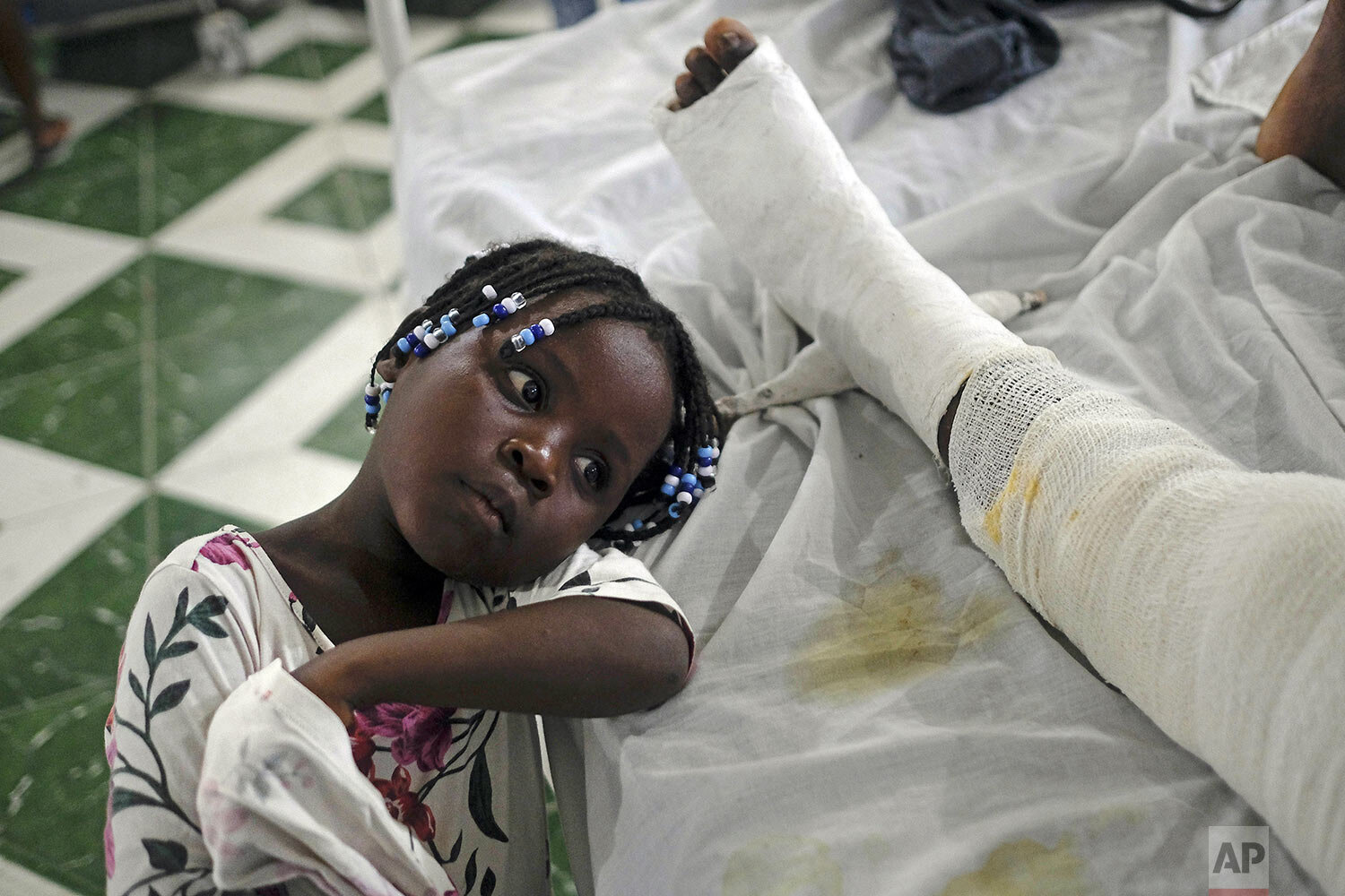  Younaika rests next to her mother Jertha Ylet, who was injured in the 7.2 magnitude earthquake one week prior, at the Immaculate Conception Hospital in Les Cayes, Haiti, Aug. 22, 2021. The quake brought down their house, killing Ylet's father and tw