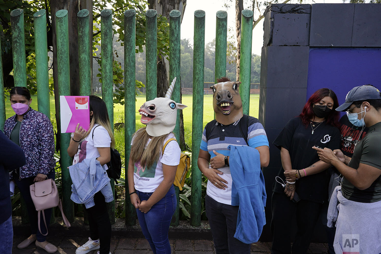  Youths, some wearing masks, wait in line to be vaccinated with the Pfizer vaccine for COVID-19 during a campaign for people between ages18-29 in Mexico City, Aug. 19, 2021. Xochimilco encouraged youths to arrive in costumes and compete for prizes if