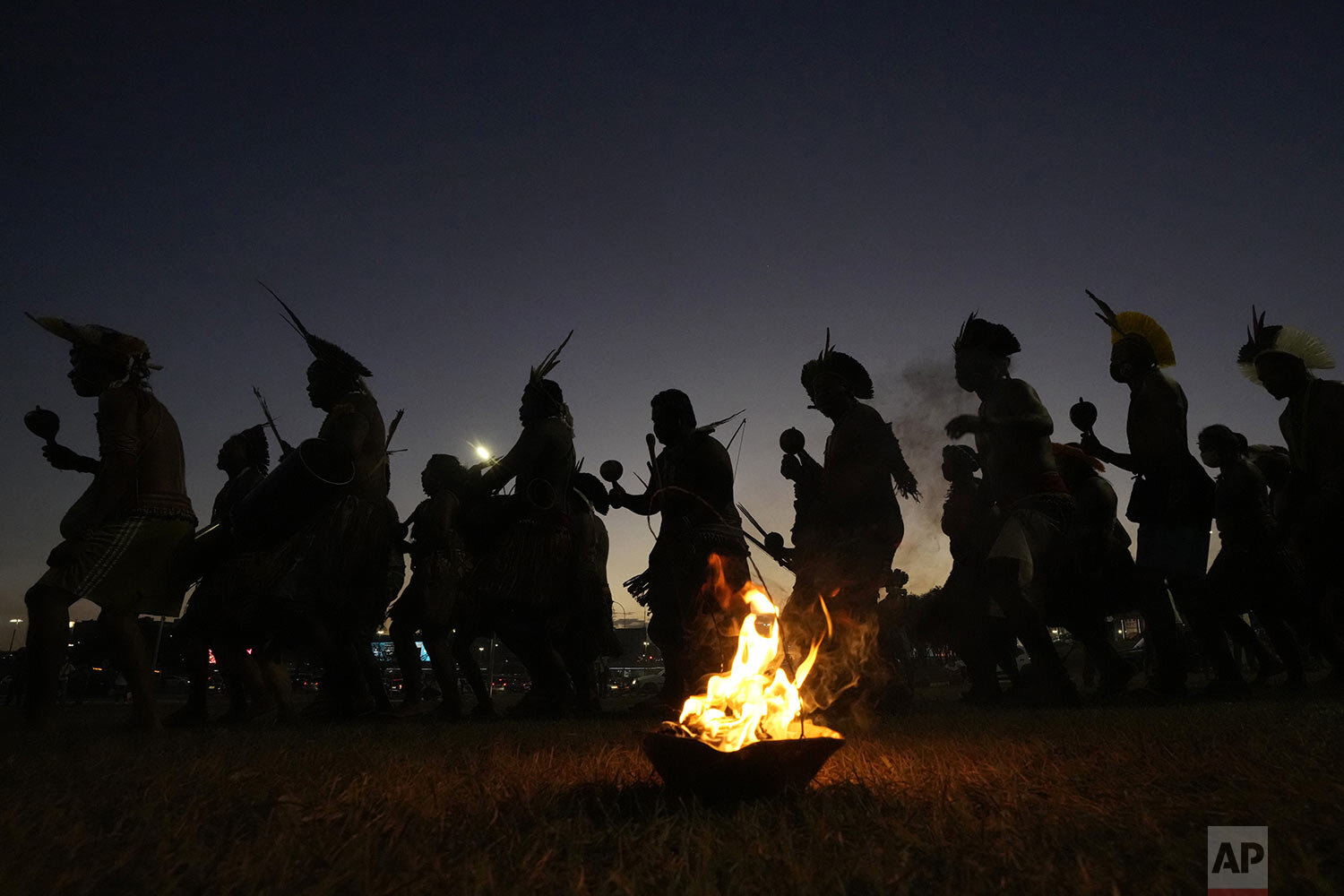  Indigenous men perform a ritual dance as Indigenous groups set up the "Luta pela Vida" or Struggle for Life camp, in Brasilia, Brazil, Aug. 23, 2021, during a weeklong mobilization to protest a Supreme Court ruling that could undermine rights to the