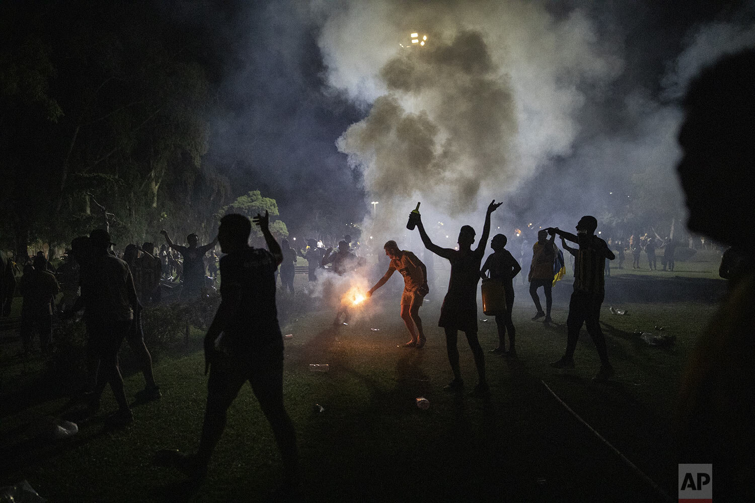  Rosario Central soccer fans light flares in a public square a few blocks from the stadium before the start of a match between their team and Newell's Old Boys amid COVID-19 pandemic restrictions banning fans from stadiums in Rosario, Argentina, May 