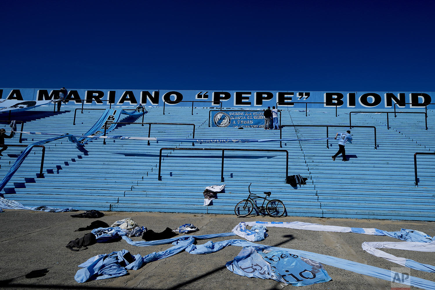  Temperley soccer fans hang banners in the empty stands of Alfredo Beranger Stadium before their team's match against Club Atletico Alvarado in Lomas de Zamora, Argentina, Friday, Aug. 27, 2021. (AP Photo/Natacha Pisarenko) 