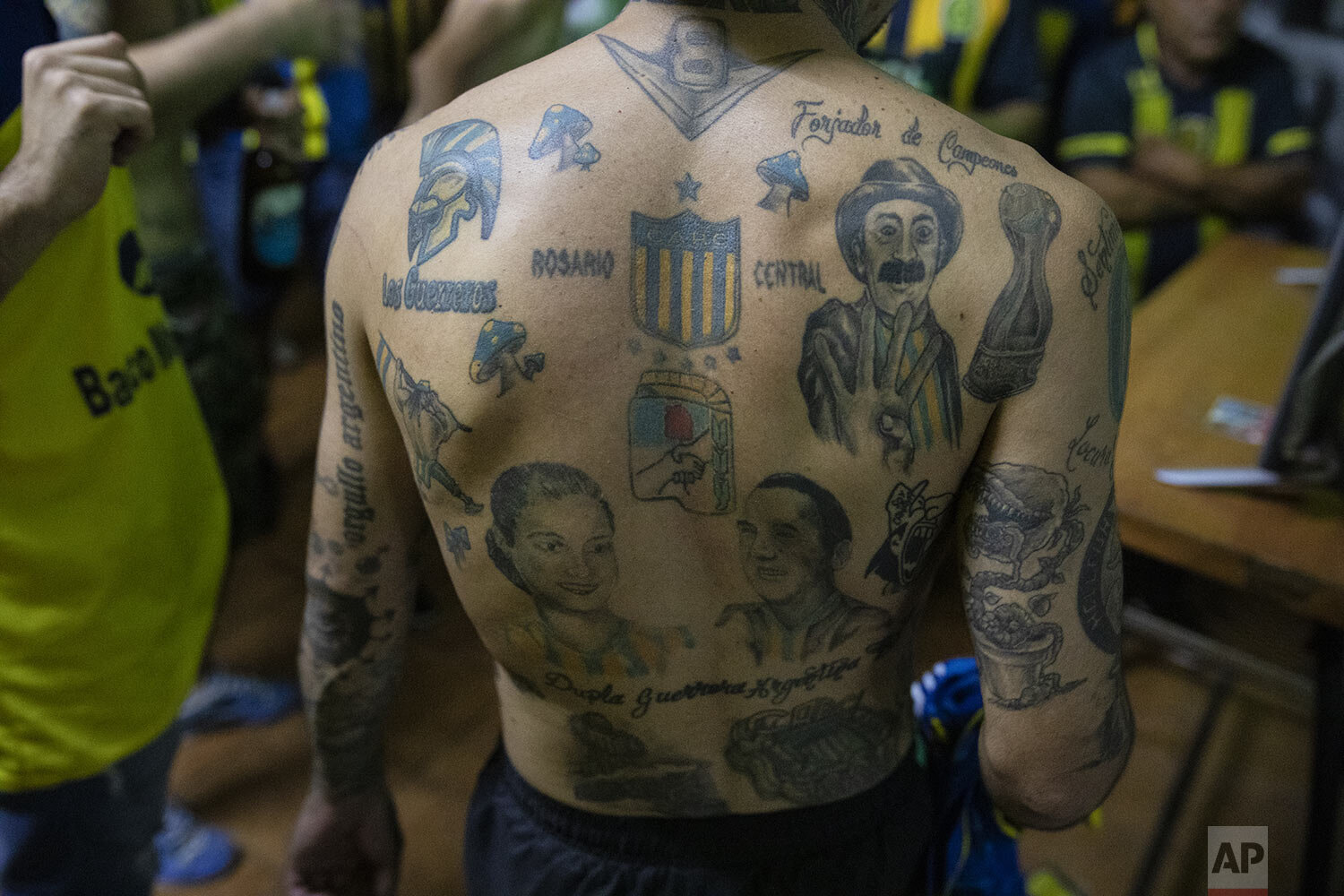  A Rosario Central soccer fan's back is filled with tattoos, with his team's shield at center, during a gathering by the team's fan club "Defensores de Tablada" to watch the team's match against Newell's Old Boys on television amid COVID-19 restricti