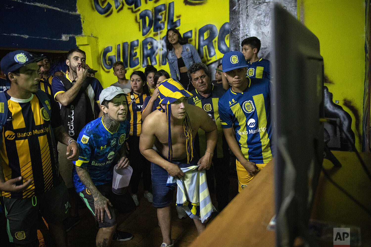  Rosario Central soccer fan club members of "Defensores de Tablada" watch their team's match against Newell's Old Boys on a home's back porch while fans are banned from attending games in person in Rosario, Argentina, May 2, 2021. (AP Photo/Rodrigo A