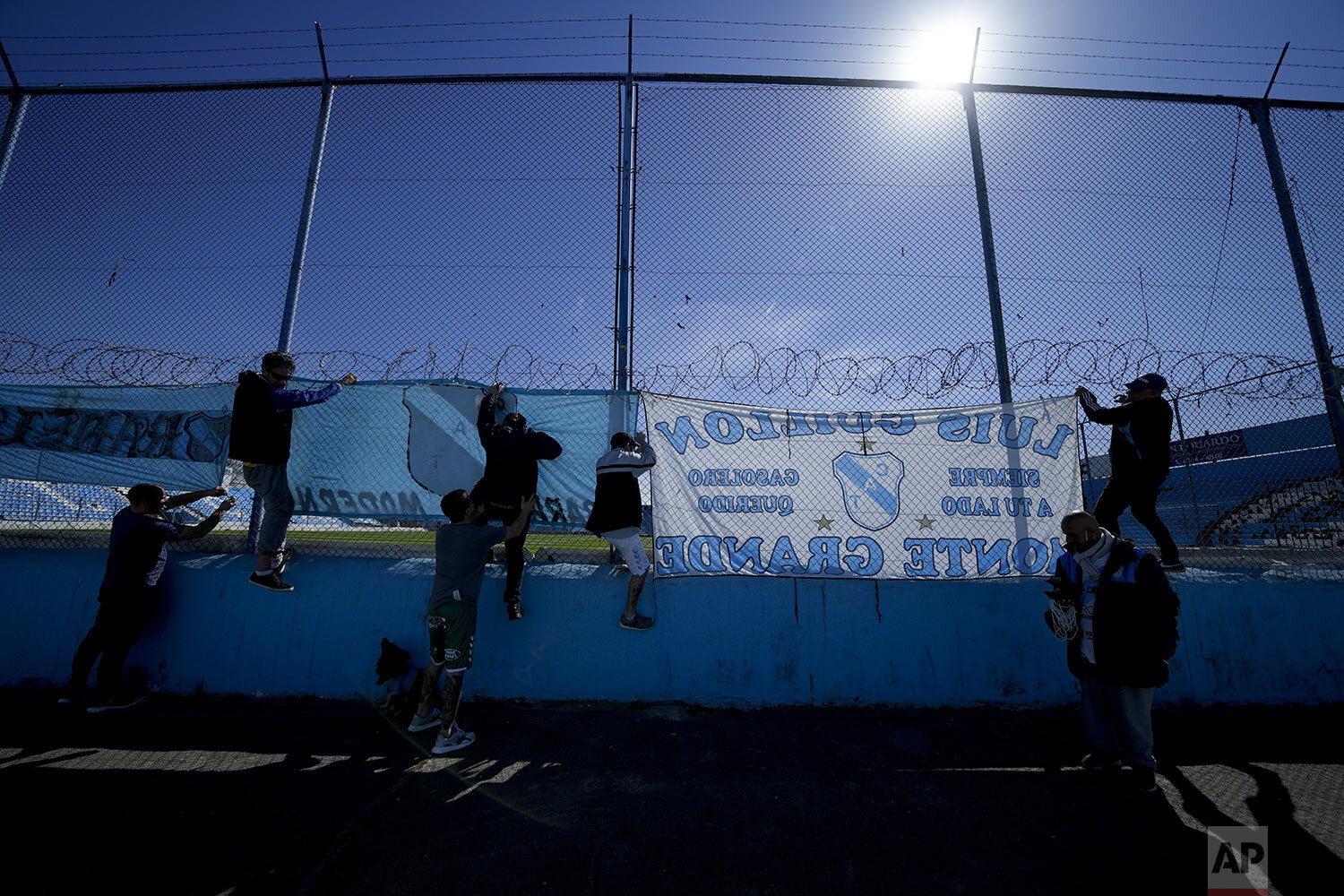  Temperley soccer fans hang banners before their team's match against Club Atletico Alvarado at the Alfredo Beranger Stadium, devoid of fans due to COVID-19 restrictions in Lomas de Zamora, Argentina, Aug. 27, 2021. (AP Photo/Natacha Pisarenko) 