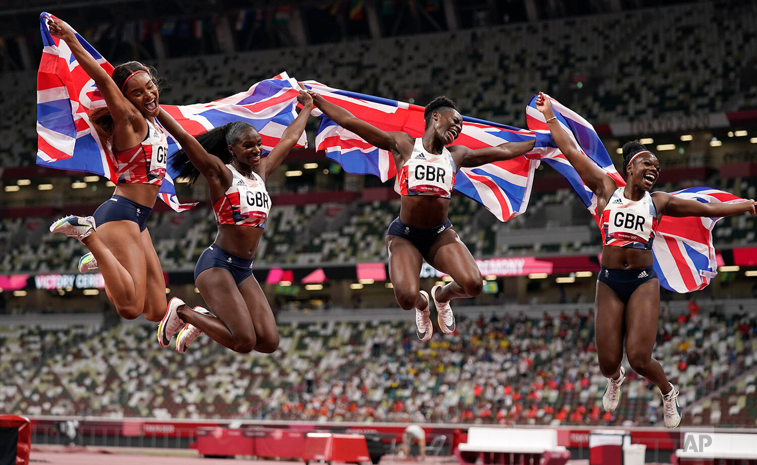  From right: Asha Philip, of Britain, Daryll Neita, Dina Asher-Smith and Imani Lansiquot, celebrate after winning the bronze medal in the final of the women's 4 x 100-meter relay at the 2020 Summer Olympics, Friday, Aug. 6, 2021, in Tokyo.  (AP Photo