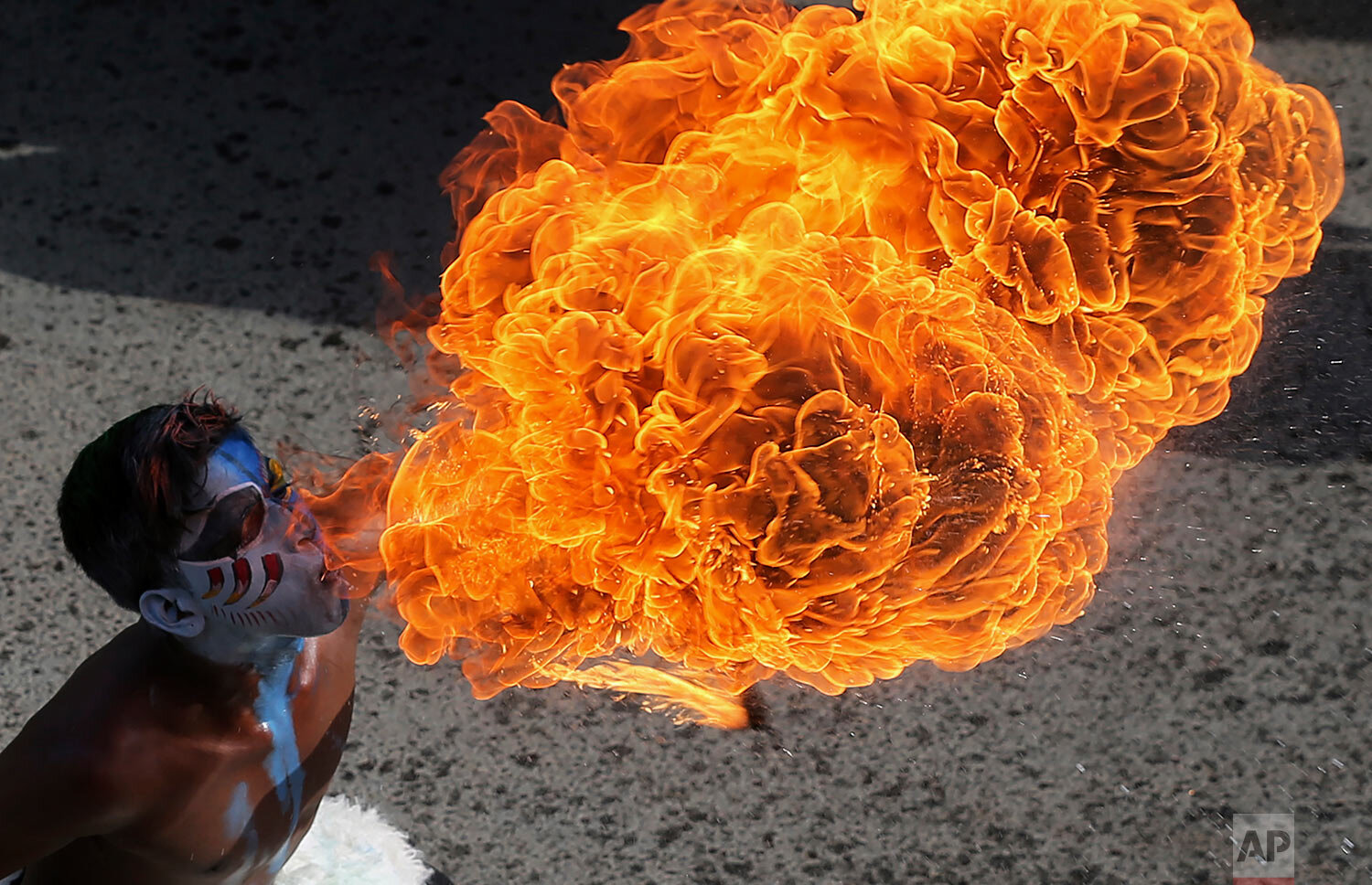  An Indian artist performs a fire act during a procession as part of "Bonalu" festival in Hyderabad, India, Monday, Aug. 2, 2021. (AP Photo/Mahesh Kumar A.) 