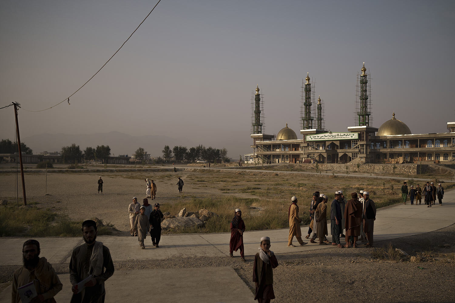 Afghan students walk out of the mosque at the Khatamul Anbiya madrasa after morning prayers in Kabul, Afghanistan, Wednesday, Sept. 29, 2021. (AP Photo/Felipe Dana)