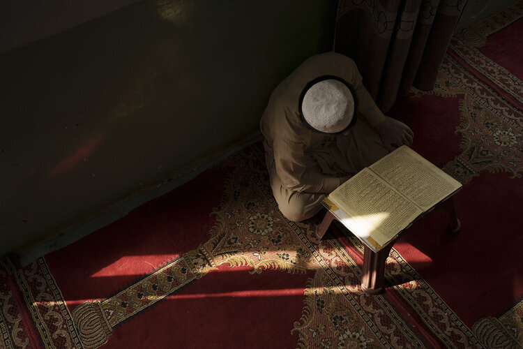 An Afghan boy reads the Quran, Islam's holy book, during class at a madrasa in Kabul, Afghanistan, Tuesday, Sept. 28, 2021. (AP Photo/Felipe Dana)