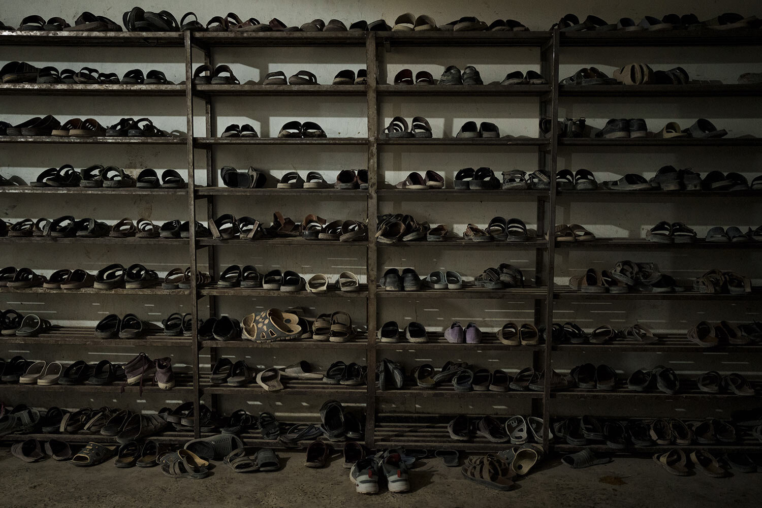 Shoes of students are placed at the entrance of the dining hall of the Khatamul Anbiya madrasa in Kabul, Afghanistan, Tuesday, Sept. 28, 2021. (AP Photo/Felipe Dana)