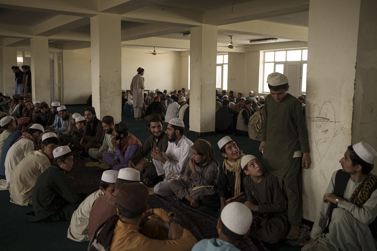 Afghan students wait for breakfast to be served at the dining hall of the Khatamul Anbiya madrasa in Kabul, Afghanistan, Wednesday, Sept. 29, 2021. (AP Photo/Felipe Dana)