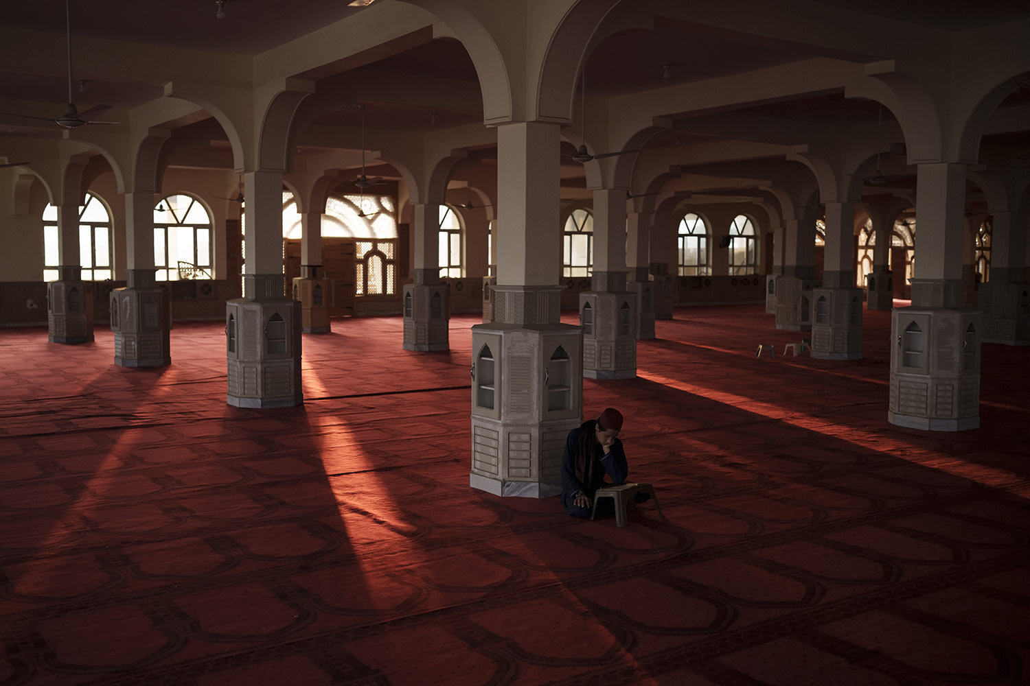 An Afghan student reads the Quran, Islam's holy book, at the mosque of the Khatamul Anbiya madrasa in Kabul, Afghanistan, Wednesday, Sept. 29, 2021. (AP Photo/Felipe Dana)