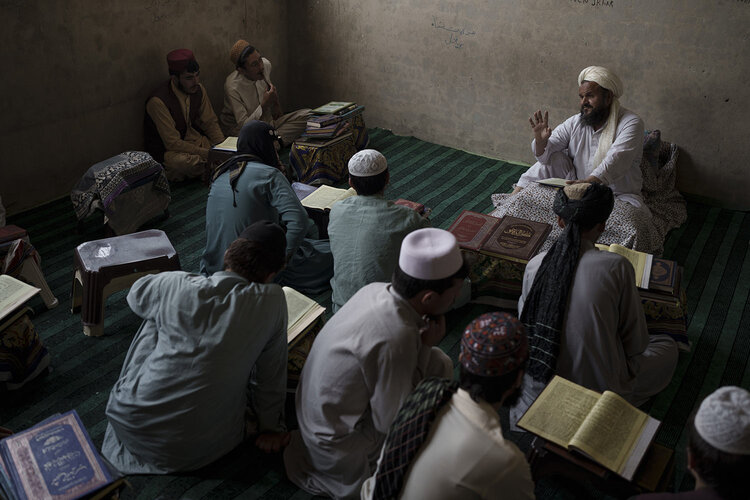 A teacher talks to students during class at the Khatamul Anbiya madrasa in Kabul, Afghanistan, Wednesday, Sept. 29, 2021. (AP Photo/Felipe Dana)