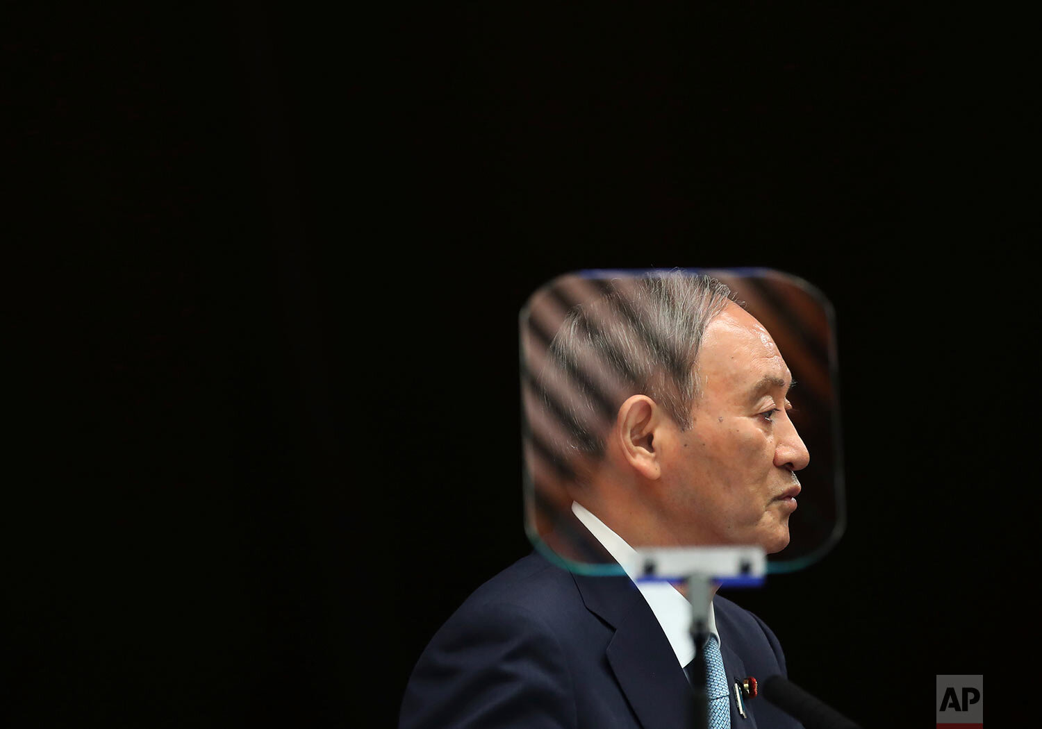  Japanese Prime Minister Yoshihide Suga is seen through a teleprompter as he speaks during his news conference at his office in Tokyo, Thursday, Sept. 9, 2021. (Kim Kyung-Hoon/Pool Photo via AP) 