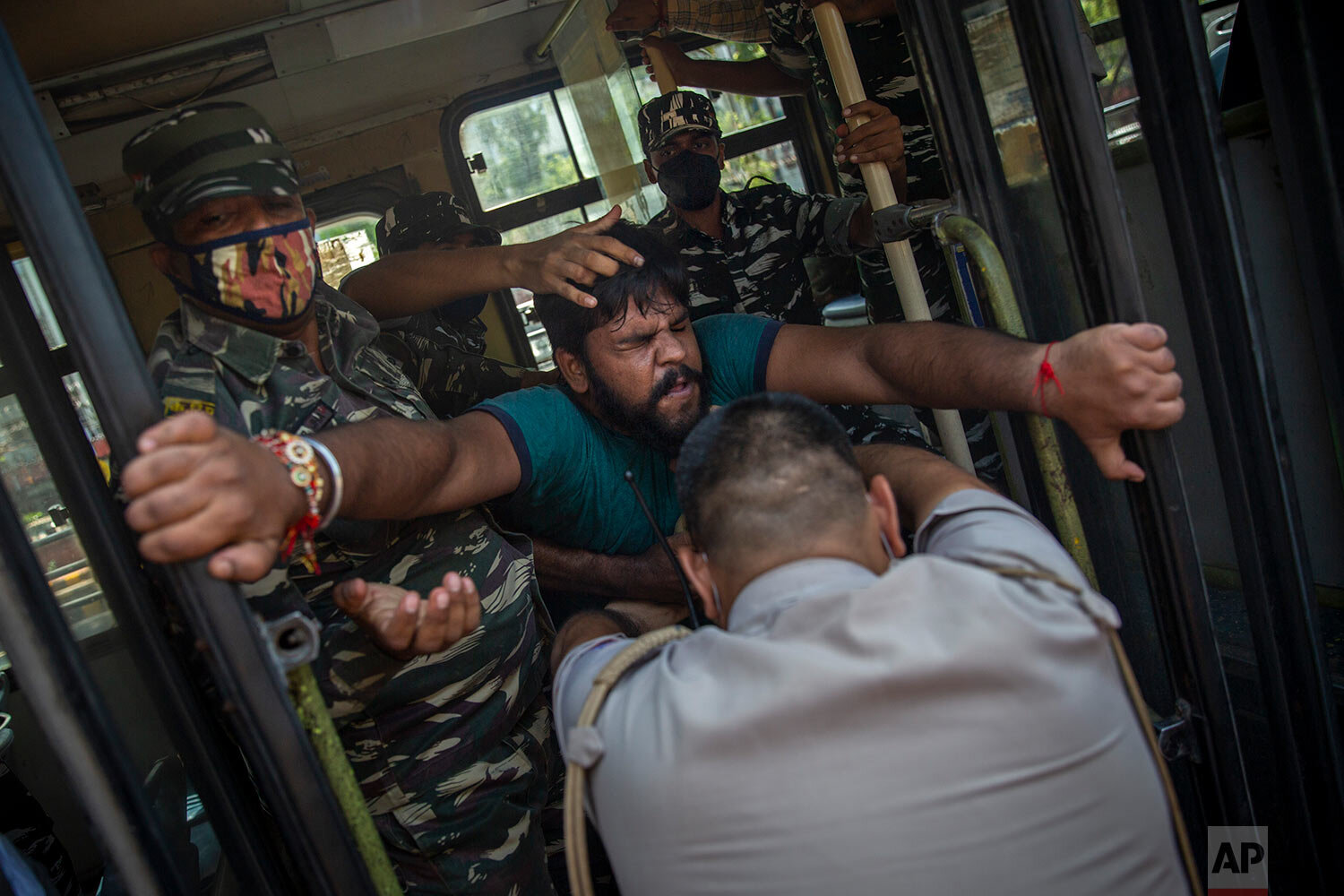  A Congress party supporter is pushed inside a bus as he is being detained during a protest against repeated hike of fuel and cooking gas prices in New Delhi, India, Thursday, Sept. 2, 2021. (AP Photo/Altaf Qadri) 