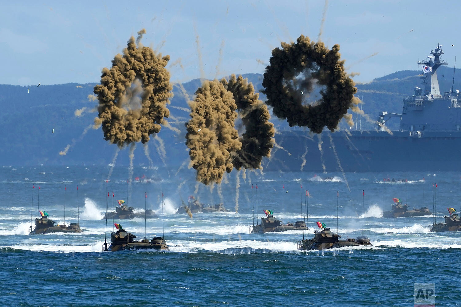  South Korean Marine's amphibious assault vehicles sail to shores in a smoke screen for landing during the media day for the 73rd anniversary of Armed Forces Day on Oct. 1, in Pohang, South Korea, Thursday, Sept. 30, 2021. (AP Photo/Lee Jin-man, Pool