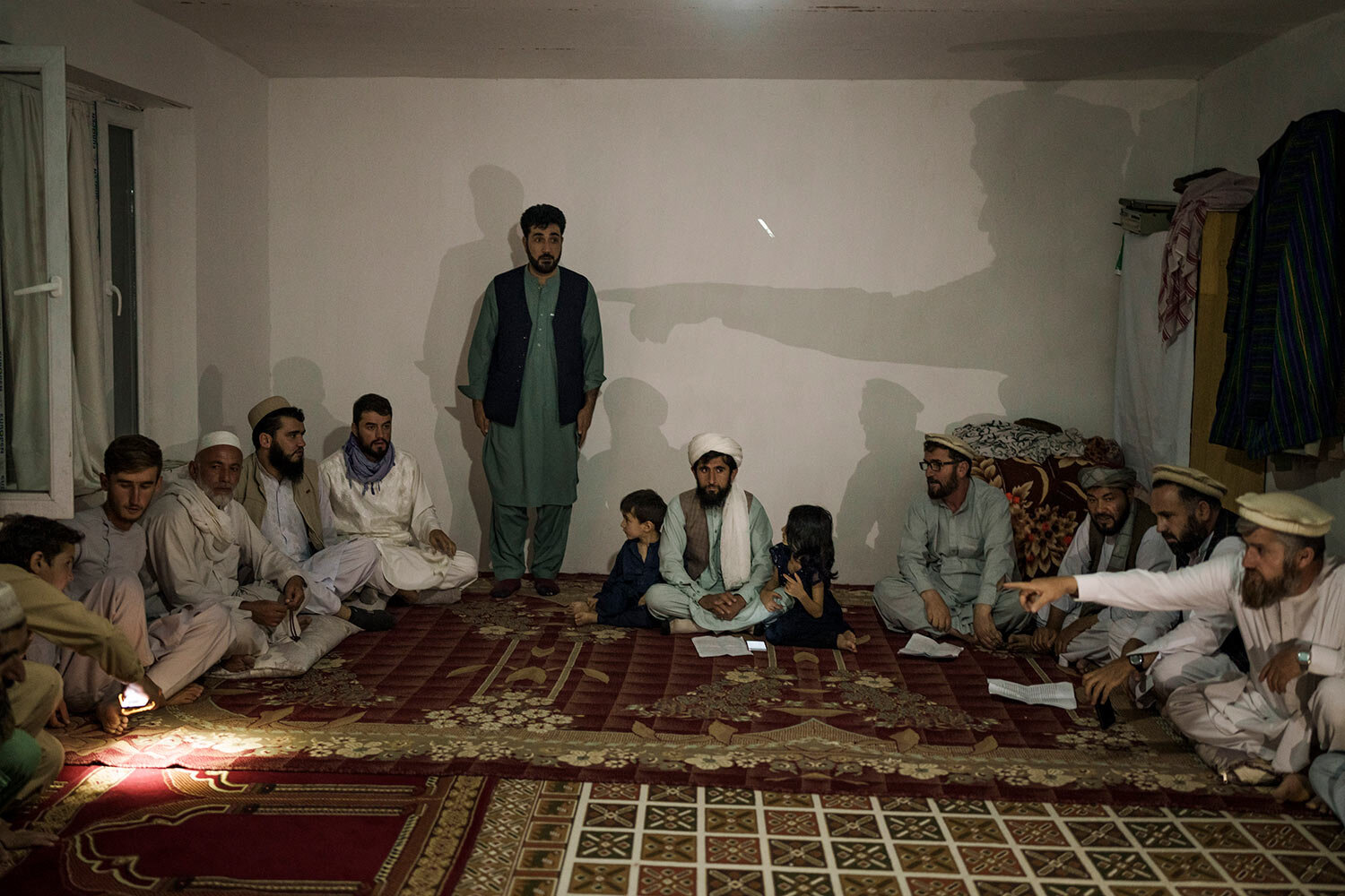  Muhammad Jawid, the father of a man accused of stabbing a neighbor, stands inside a room where a committee of local elders judge the incident and determine the verdict, in Kabul, Afghanistan, Saturday, Oct. 2, 2021. Jawid’s son was declared guilt an