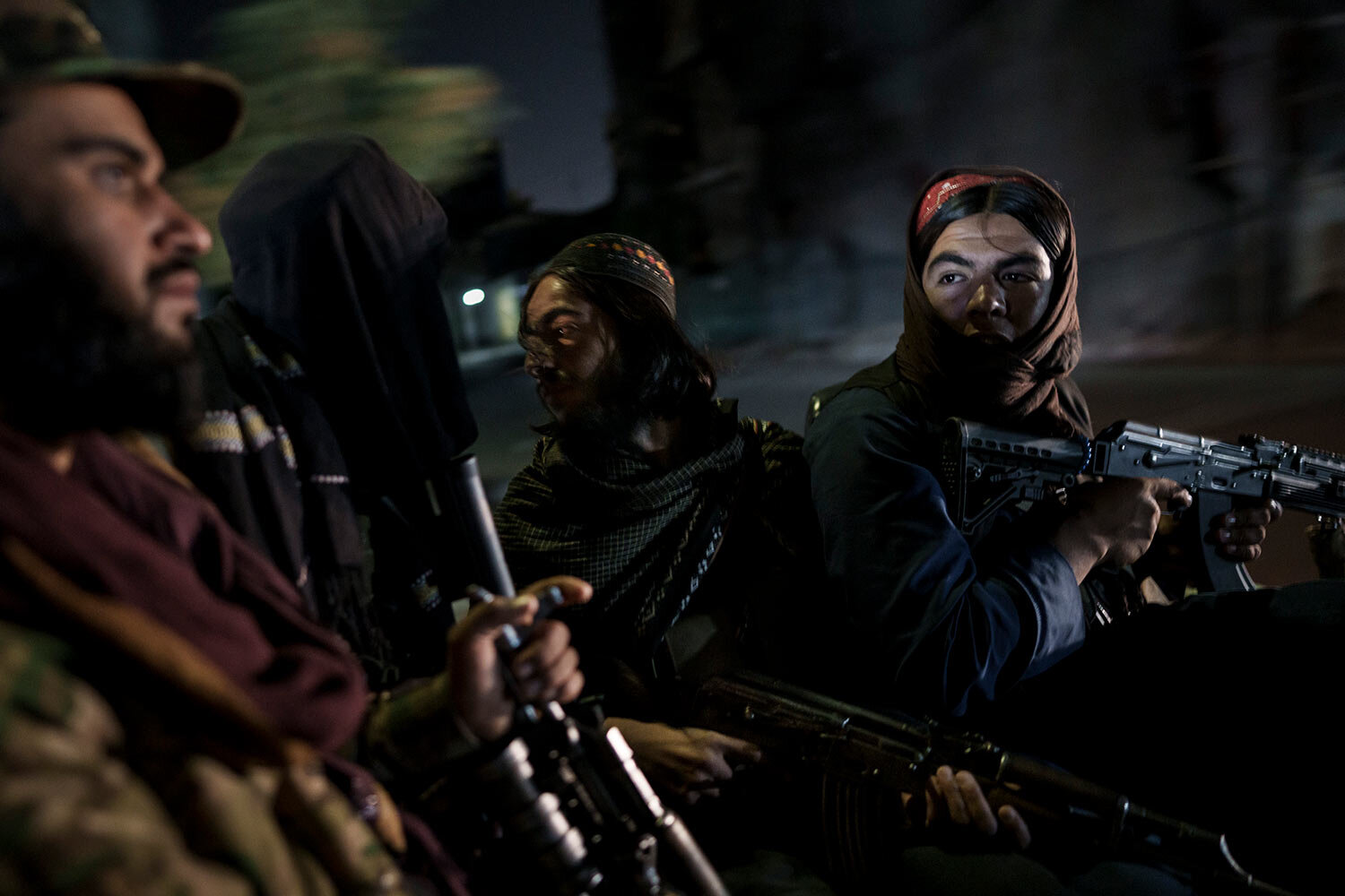  Taliban fighters ride in the back of a vehicle during a night patrol in Kabul, Afghanistan, Sunday, Sept. 12, 2021. (AP Photo/Felipe Dana) 