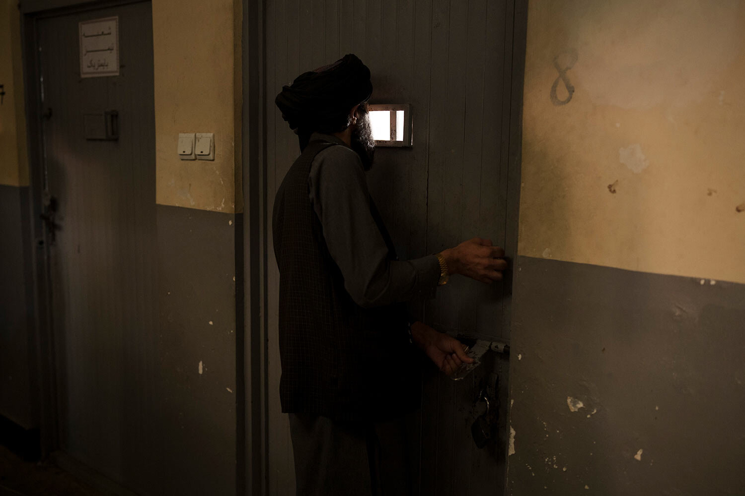  A Taliban fighter looks into a holding cell for detainees at a police station in Kabul, Afghanistan, Sunday, Sept. 19, 2021. (AP Photo/Felipe Dana)  