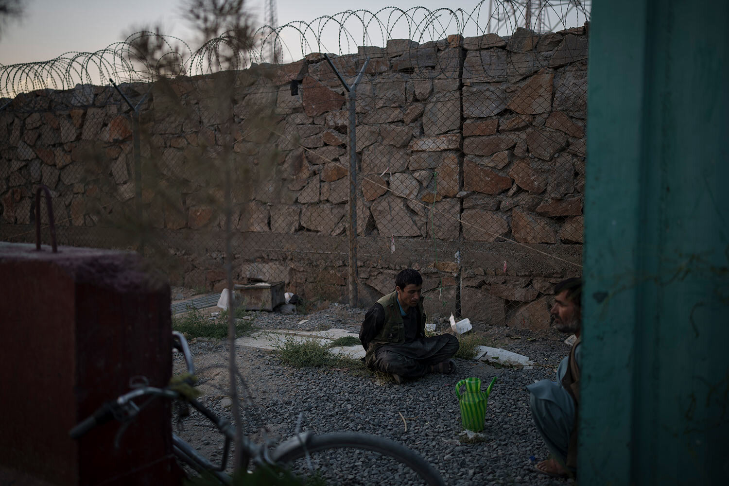  Two men detained by Taliban fighters sit at the entrance of a police station in Kabul, Afghanistan, Tuesday, Sept. 21, 2021. (AP Photo/Felipe Dana)  