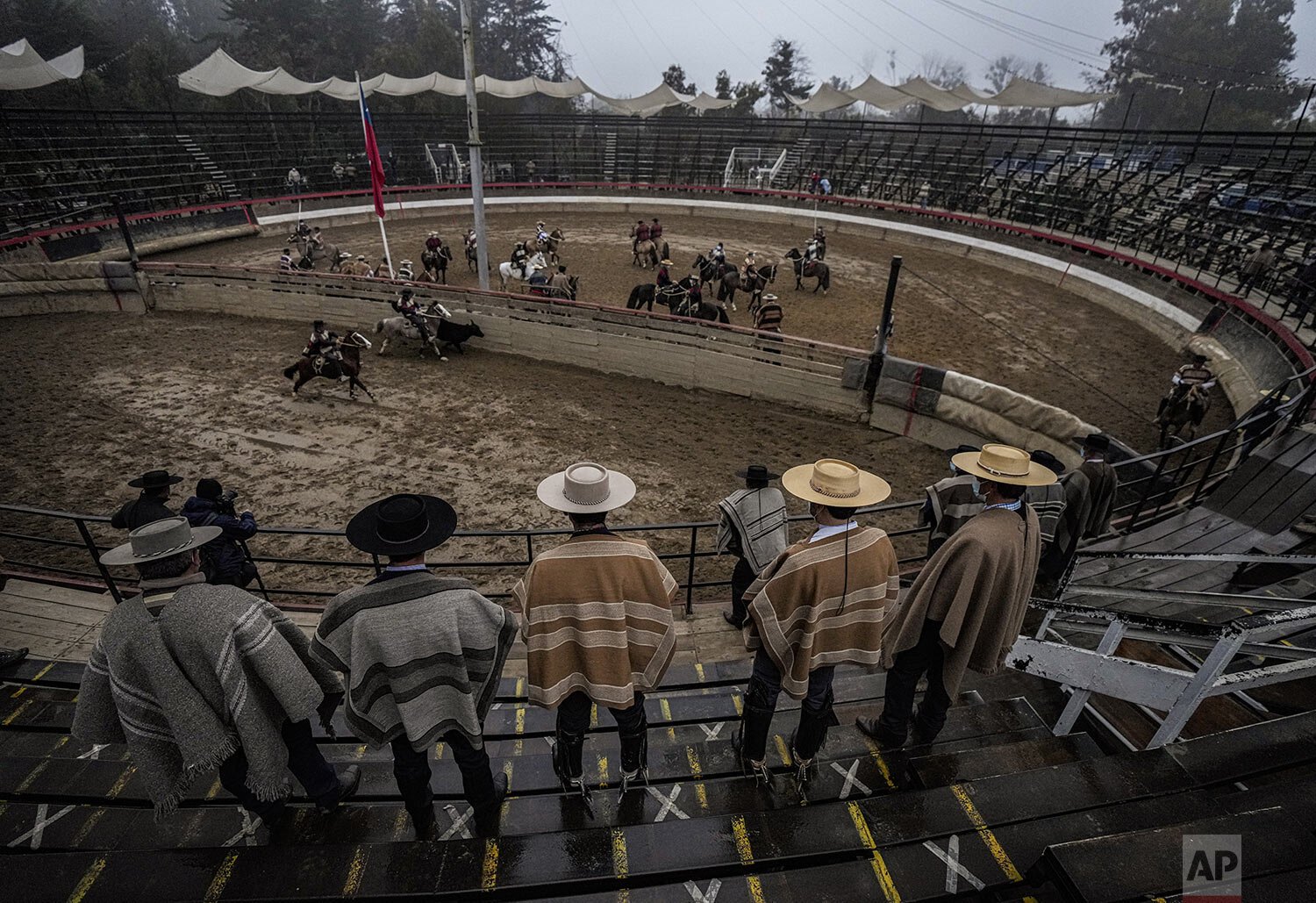  Horseback riders attend a rodeo, a centerpiece of the country's Independence Day celebrations, at an arena empty of spectators due to COVID-19 restrictions in Melipilla, Sept. 18, 2021. (AP Photo/Esteban Felix) 