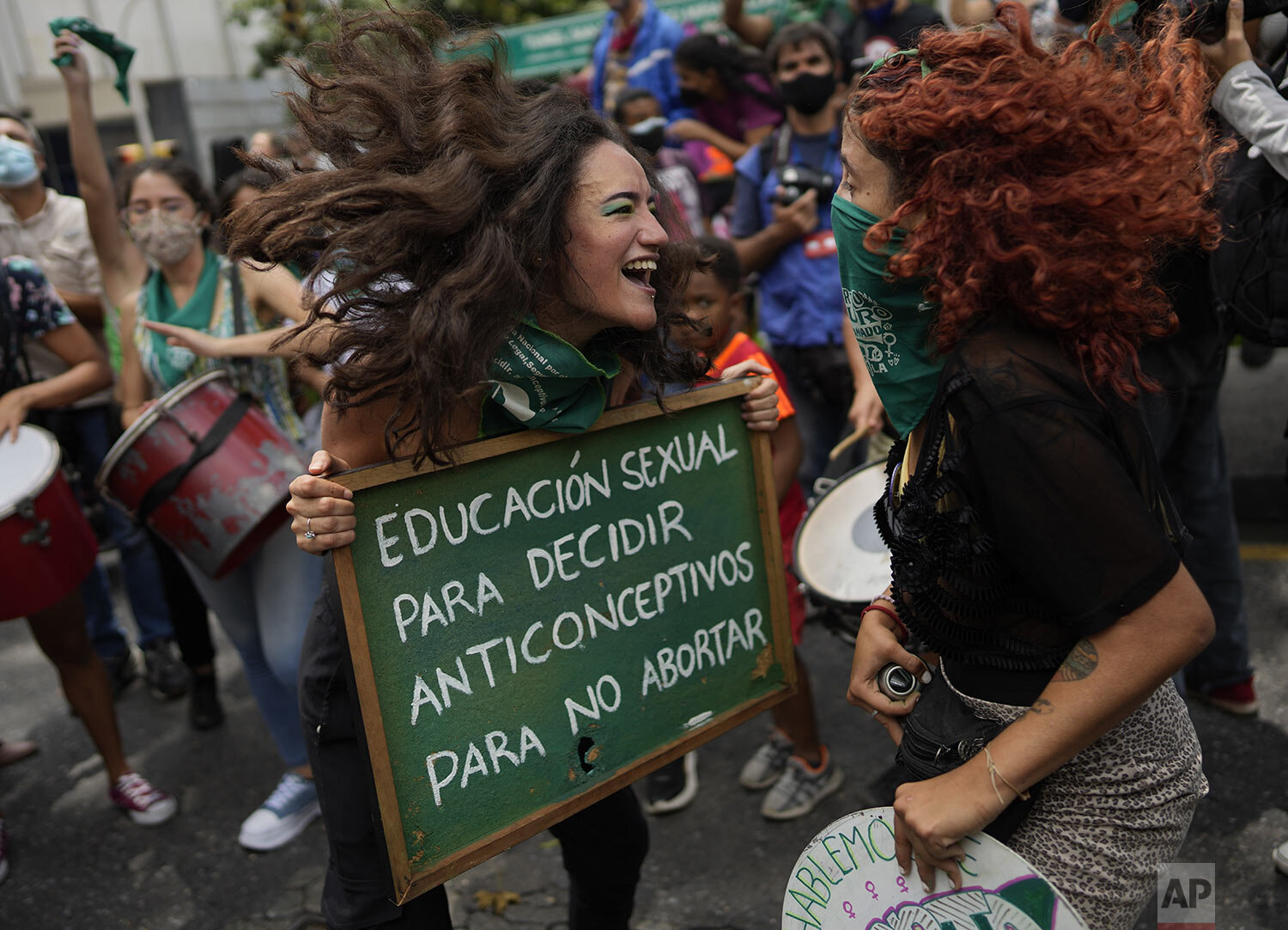  A woman holds the Spanish message: "Sex education to decide, contraceptives to avoid abortion," on the Global Day of Action for access to legal, safe and free abortion, outside the National Assembly in Caracas, Venezuela, Sept. 28, 2021. (AP Photo/A