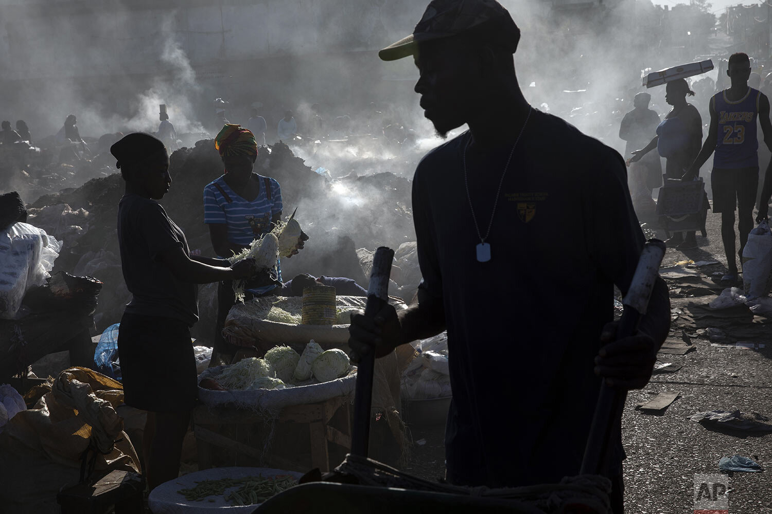  Vendors shred cabbage in the Croix des Bosalles market in Port-au-Prince, Haiti, Sept. 13, 2021. The city's main food market extends from the port to parliament, where enslaved people were sold before Haiti’s independence. (AP Photo/Rodrigo Abd) 