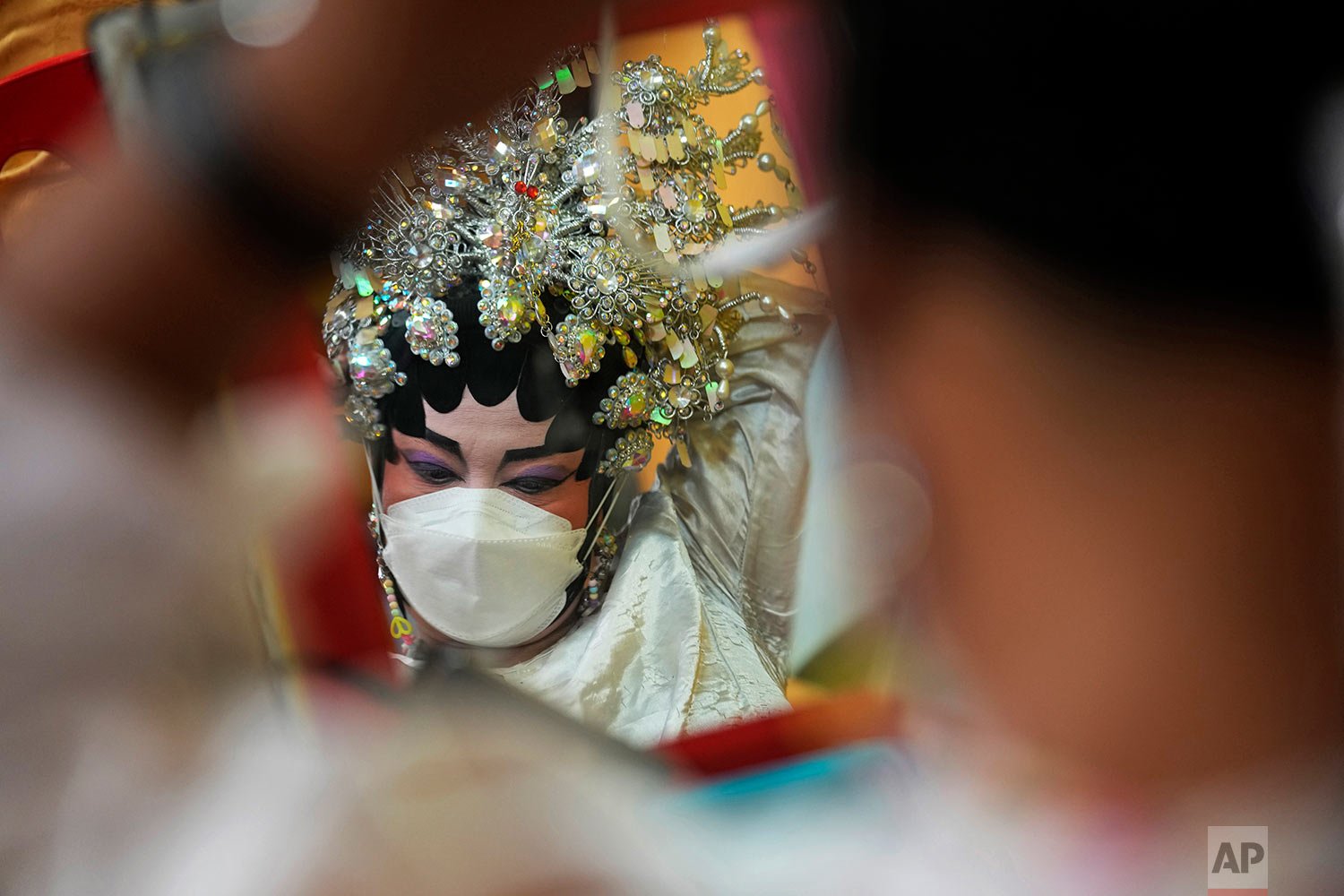  A Chinese opera performer wearing a face mask to help curb the spread of the coronavirus prepares for the stage in Bangkok, Thailand, Wednesday, Oct. 6, 2021. (AP Photo/Sakchai Lalit) 