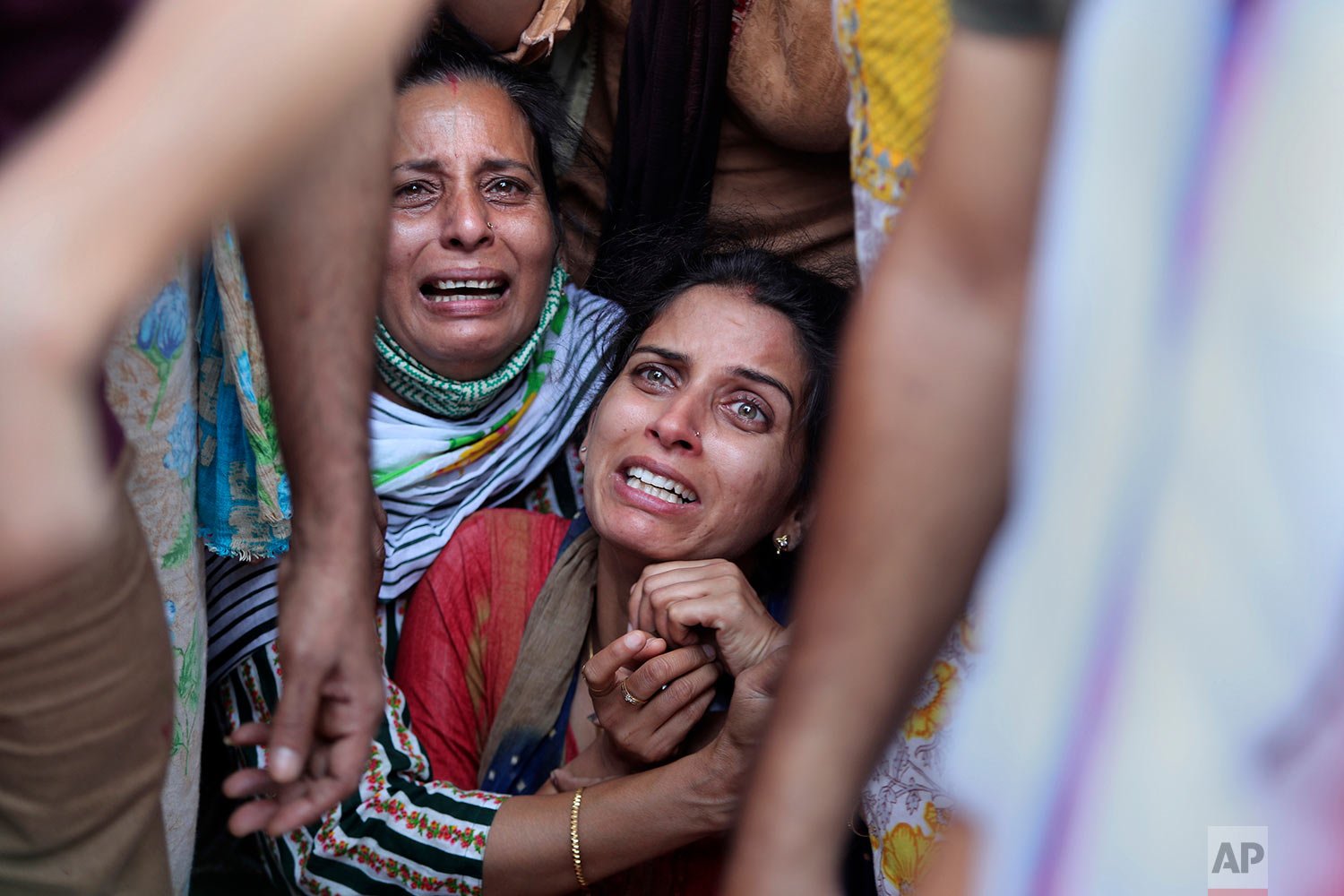  Aradhana, center, wife of Deepak chand, a school teacher who was killed in Kashmir, mourns before his cremation in Jammu, India, Friday, Oct.8, 2021.  (AP Photo/Channi Anand) 