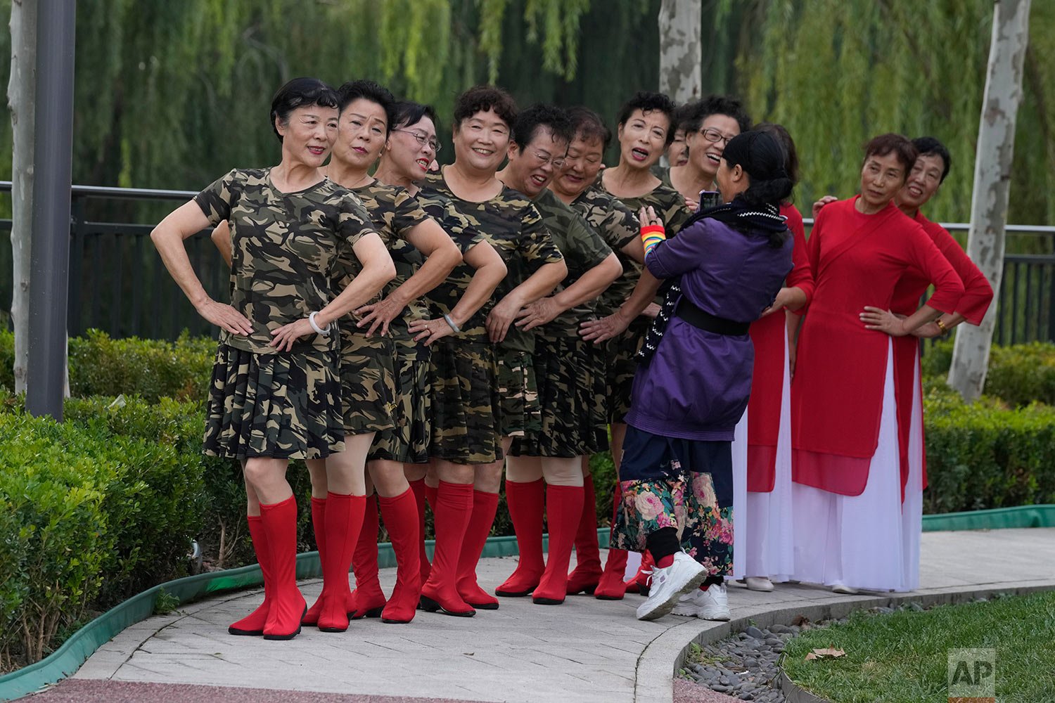  Dancers pose for photos at a park in Beijing, China, Thursday, Oct. 14, 2021. (AP Photo/Ng Han Guan) 