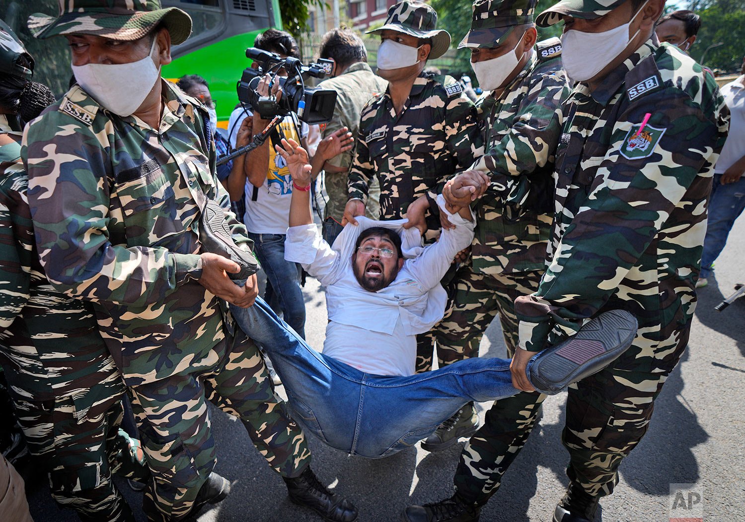  Paramilitary force soldiers detain an activist of Congress party's youth wing protesting against Sunday's killing of four farmers in Uttar Pradesh state after being run over by a car owned by India's junior home minister in New Delhi, India, Monday,