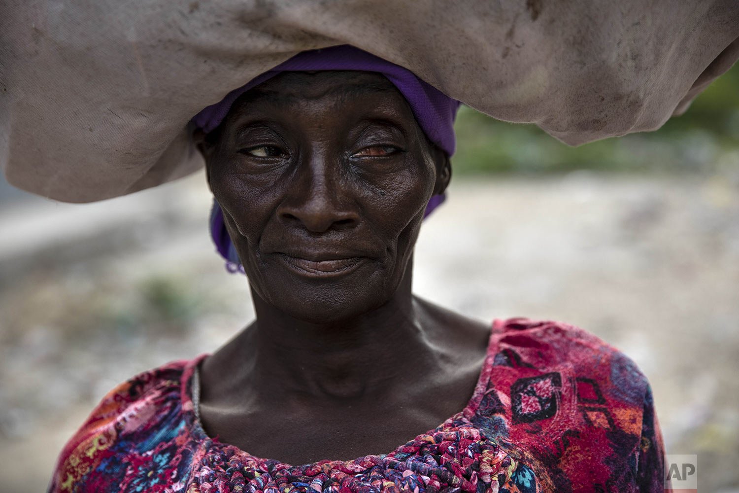  Adriana, 50, poses for the photo while walking in the Bel- Air neighborhood of Port-au-Prince, Haiti, Oct. 5, 2021. (AP Photo/Rodrigo Abd) 