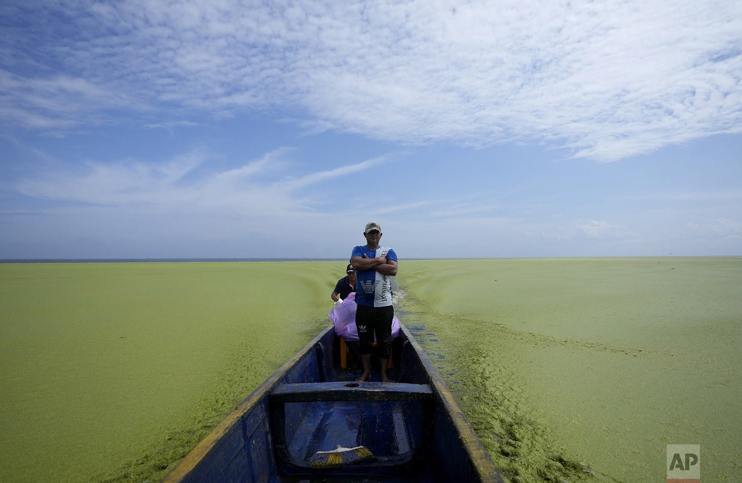  A fisherman stands on a boat in Cienaga Grande de Santa Marta marsh in Nueva Venecia, Colombia, Oct. 12, 2021. About 400 families live in stilt houses in the Cienaga Grande, the largest of the swampy marshes located in Colombia between the Magdalena